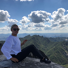 a man sitting on top of a mountain