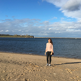 a person standing on a beach near a body of water