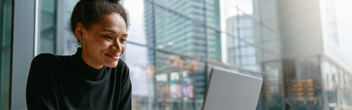 female student at laptop in city