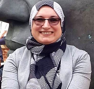 a woman wearing a hat and smiling at the camera