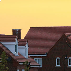 Close up of brick houses against yellow sky