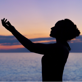 Silhouette of woman in a spiritual position