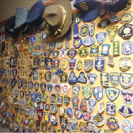 Photo showing lots of different police hats and badges