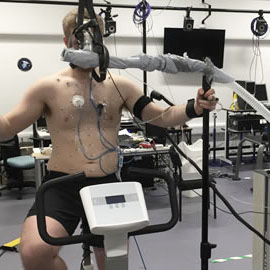 Image of a man using an exercise machine in a lab setting