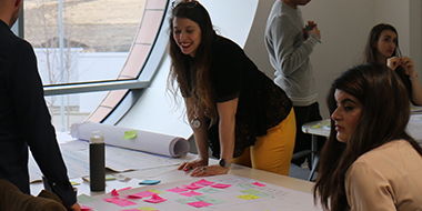 Photo showing researchers around a table with sticky notes