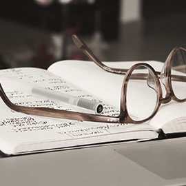 Image of glasses resting on a notebook