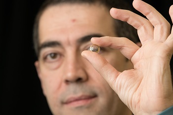 Caption:Professor Hamdi Torun pictured holding the contact lens