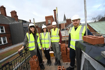 Caption:Paul Ring (right) pictured with Architecture students during the building of the new studios