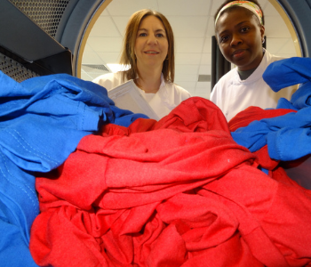 Caption: Dr Kelly Sheridan and PhD student Chimdia Kechi Okafor run a test load in a tumble dryer.