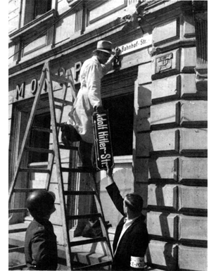 Adolf Hitler street sign is taken down in the German city of Trier, during post-war denazification.