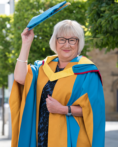 Pat Ritchie in academic dress on the University's City Campus before receiving her Honorary Degree