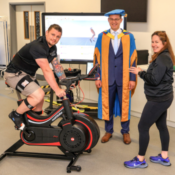Caption: Jon Dutton OBE is given a cycle training system demonstration by Northumbria staff.