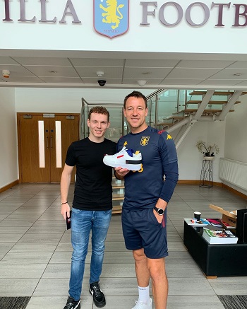 Caption:Ollie Simspon delivering trainers to John Terry