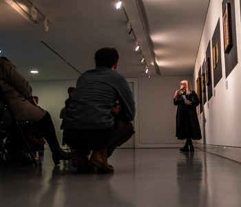 Caption: Claire A Baker introduces The Red Thread exhibition. Image credit, Craig McCann McMillan.