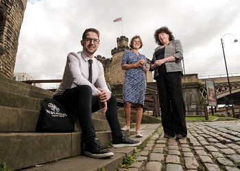 Caption:Northumbria University student Christopher Brownhill pictured with Caroline Theobald CBE and Zélie Guérin