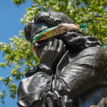 Caption: Bristol / England - May 6th 2020: Statue of Edward Colston with blindfold before it was taken down by protestors. Image from Shutterstock by Ian Luck