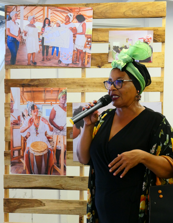 Caption: At the exhibition in Esmeraldas, peer researcher Rosa Tejada shares information about the process of the RECLAMA research to visitors.