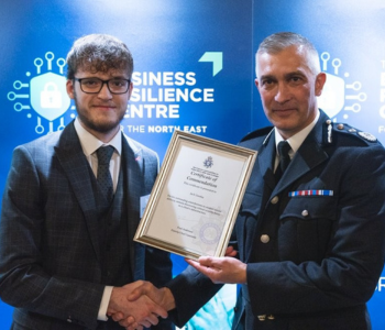 Caption: Jack Gooday with the Chief Constable of Humberside Police receiving a commendation for his work.