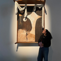 Caption: Bec Nicholson pictured with some of her work on display.