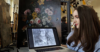caption:Art Conservation Masters student Elliot Keim with the painting she x-rayed and the portrait discovered underneath