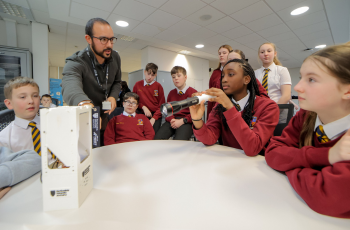 Caption: Dr Jeffersson Andres Agudelo Rueda at Northumbria University uses models and a laser torch to demonstrate how CubeSat satellites work.