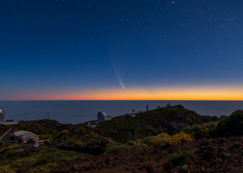 caption:The comet C/2020 F3 NEOWISE, captured before sunrise from the Observatorio Roque de los Muchachos from the Instituto de Astrofísica de Canarias (IAC), in La Palma, Canary Islands, Spain. In the picture, the Nordic Optical Telescope (left), William Herschel Telescope (center), and other observatories such as DOT and SST (both solar), LT, Mercator, INT and JKT telescopes (right). Credit: Image courtesy of the Isaac Newton Group of Telescopes, La Palma.
