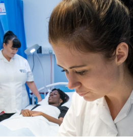 Nursing apprentice with patient