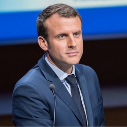 Emmanuel Macron wearing a suit and tie