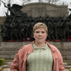 an image of Dr Linsey Robb, standing in front of a war memorial