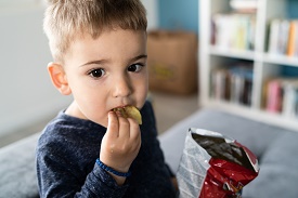 a little boy that is eating some food