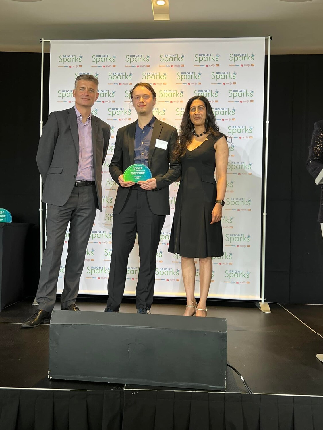 Caption: Arthur collecting his award with Richard Watts and Isabella Mascarenhas photo by Robbie Dunion