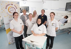 Pictured is a group of four student nurses, along with their university lecturers and healthcare professionals. 
