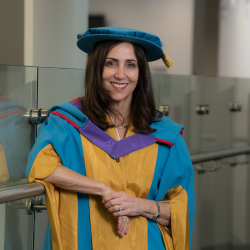 Baroness Joanna Shields OBE pictured wearing a graduation gown and smiling at the camera