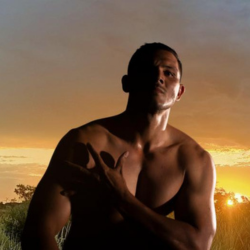A young Aborignal man, pictured outside with a sunset in the background