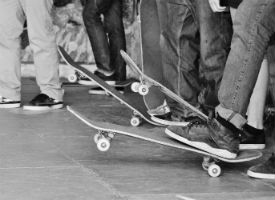 a group of people riding on a skateboard