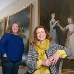 Pictured left to right is Emma Thomas, General Manager, Seaton Delaval Hall; and Nicky Grimaldi, Assistant Professor of Art Conservation, Northumbria University. They are pictured in front of three portraits hanging on the wall behind them.