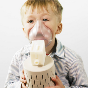 Child breathing into PulmoBioMed's PBMHale device