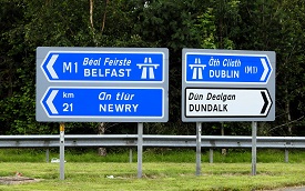 an image of two motorway signs, one pointing left to Belfast and the other pointing right to Dublin