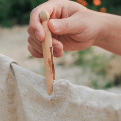Generic image of someone putting washing on line outside with wooden peg. Image from Canva.