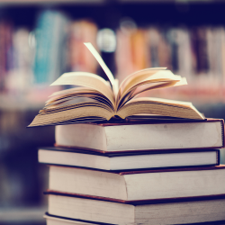 example of a history dissertation an image showing a pile of books with one open on top