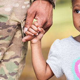 Military Connected Child holding hands with adult