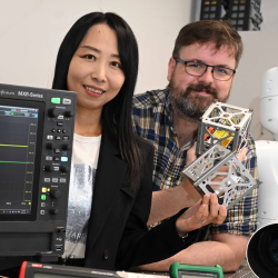 Jing Jiang and Eamon Scullion, pictured holding cube sats