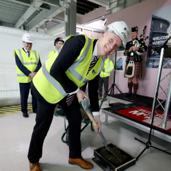 Professor John Woodward pouring final concrete at NESST topping out ceremony