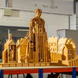 a wooden model of a miner and houses