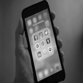 Black and white image of a mobile phone screen showing social media