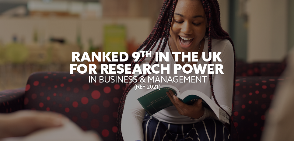 Image: Business student writing in a book, smiling. Text: "Ranked 9th in the UK for Research Power in Business and Management (REF 2021)"