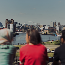 Group of students looking out over Newcastle Quayside.