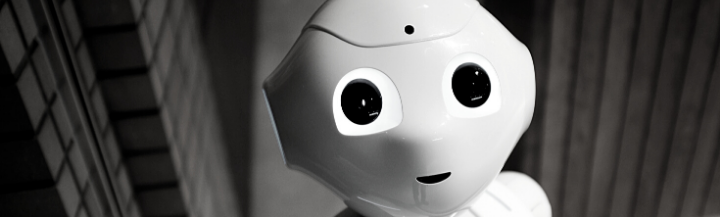 White robot with large eyes smiling