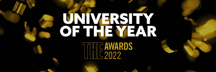 Black promotional banner with gold confetti announcing Northumbria University as the Times Higher Education University of the Year 2022