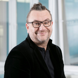a man standing in front of a window